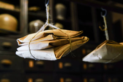 Close-up of envelopes hanging in darkroom