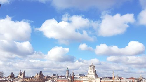 Natural history museum with cityscape against sky