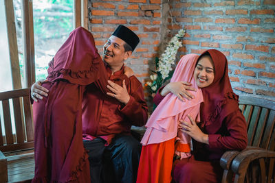 Low angle view of woman standing against wall