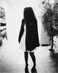 Woman holding umbrella standing outdoors