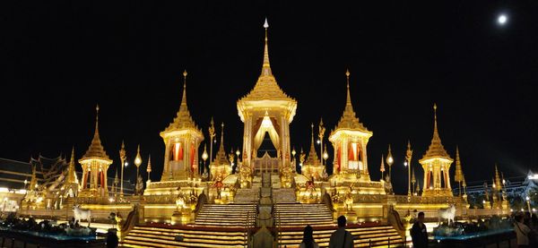 Illuminated temple against clear sky at night