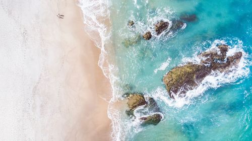 High angle view of waves splashing on shore