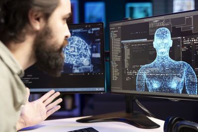 Close-up of man using laptop