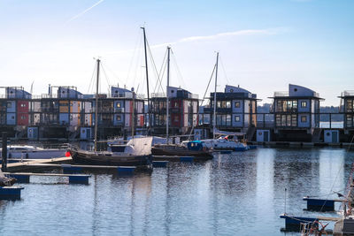 Boats moored at port against sky