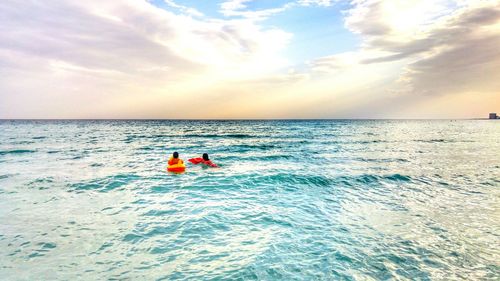 People in the sea on inflatables