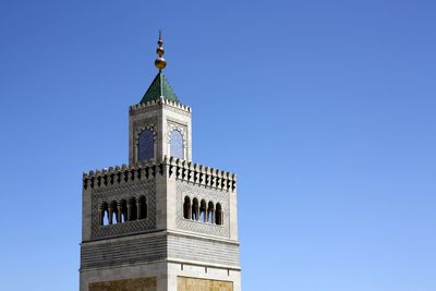 Low angle view of tower against blue sky