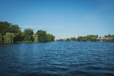 Scenic view of river against clear blue sky