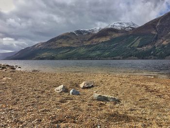 Scenic view of lake and mountains against sky