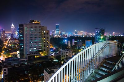 High angle view of illuminated buildings in city at night