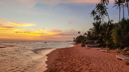 View of calm beach at sunset