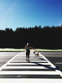 Rear view of people walking on road