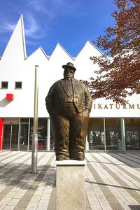 Rear view of man standing against built structure