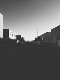 Empty road with buildings in background