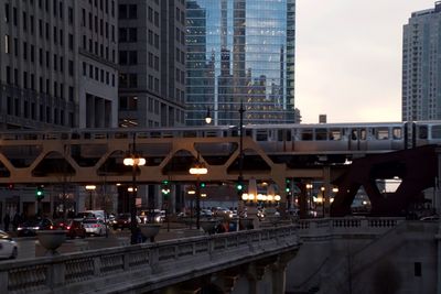 Illuminated bridge in city against sky