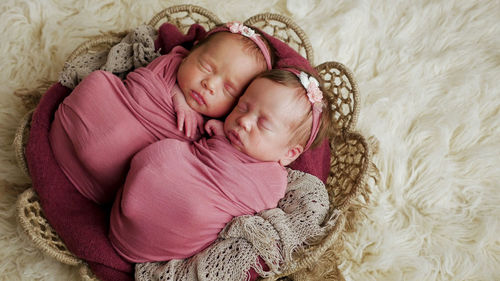 High angle view of cute baby girl lying on bed