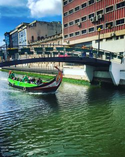 Boats in river with buildings in background