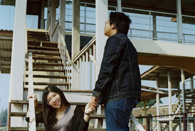 Young man and woman at railroad station