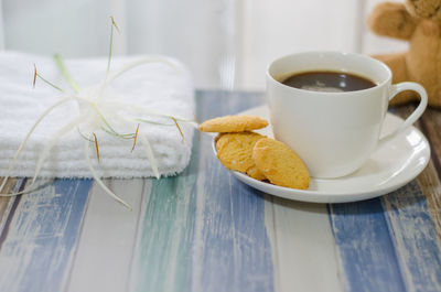 Close-up of coffee and cookies on table