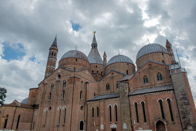 Low angle view of cathedral against cloudy sky