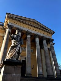 Low angle view of statue against sky