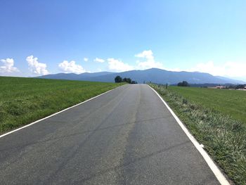 Empty road leading towards mountains