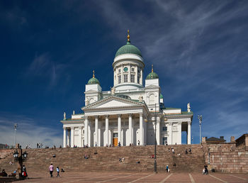 Group of people in front of building against sky