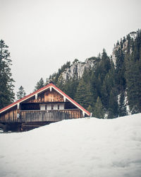 House by building against clear sky during winter