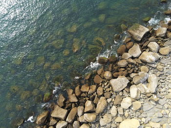 High angle view of stones in sea