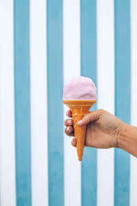 Close-up of hand holding ice cream cone