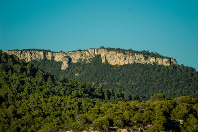 Scenic view of mountains against clear blue sky