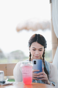 Young woman using mobile phone