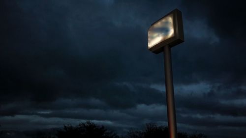 Low angle view of illuminated light against sky at night