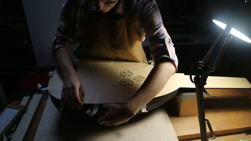 Midsection of man working at table