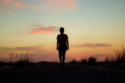 Silhouette man against sky during sunset