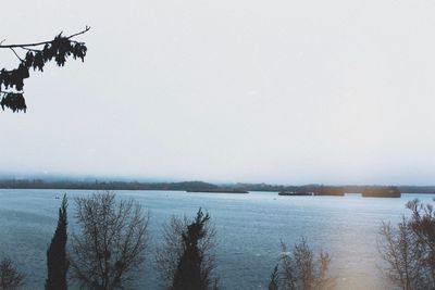 Scenic view of lake against sky during winter