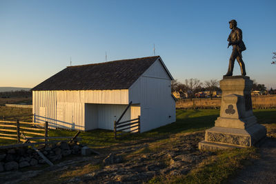 Sculpture of historic building against clear sky