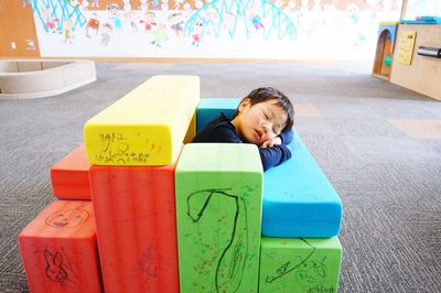 Cute boy sleeping in play school