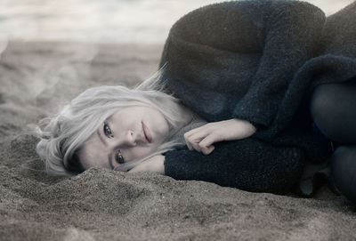 Portrait of woman lying down on land