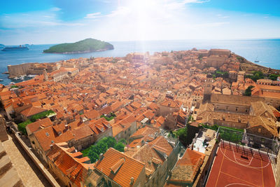 High angle view of townscape by sea against sky