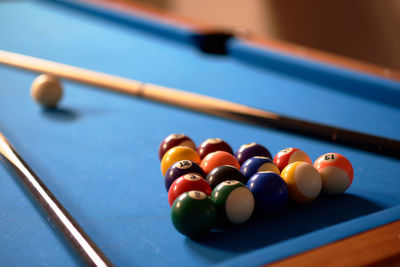 Close-up of pool balls and cue on table
