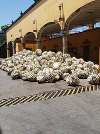 Stack of stone on street by building