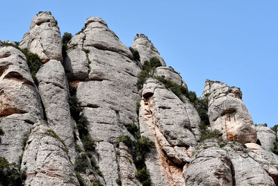 Low angle view of montserrat against clear sky