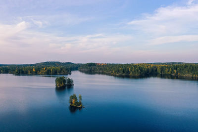 Scenic view of lake against sky and autumn color forest 