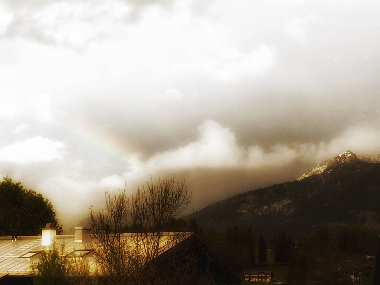 tree, weather, sky, nature, no people, cloud - sky, rainbow, scenics, beauty in nature, outdoors, built structure, tranquility, architecture, mountain, day, building exterior, water