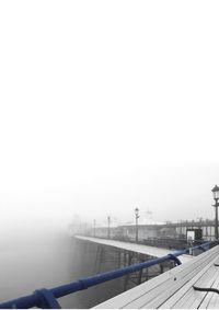 Airplane on bridge against sky