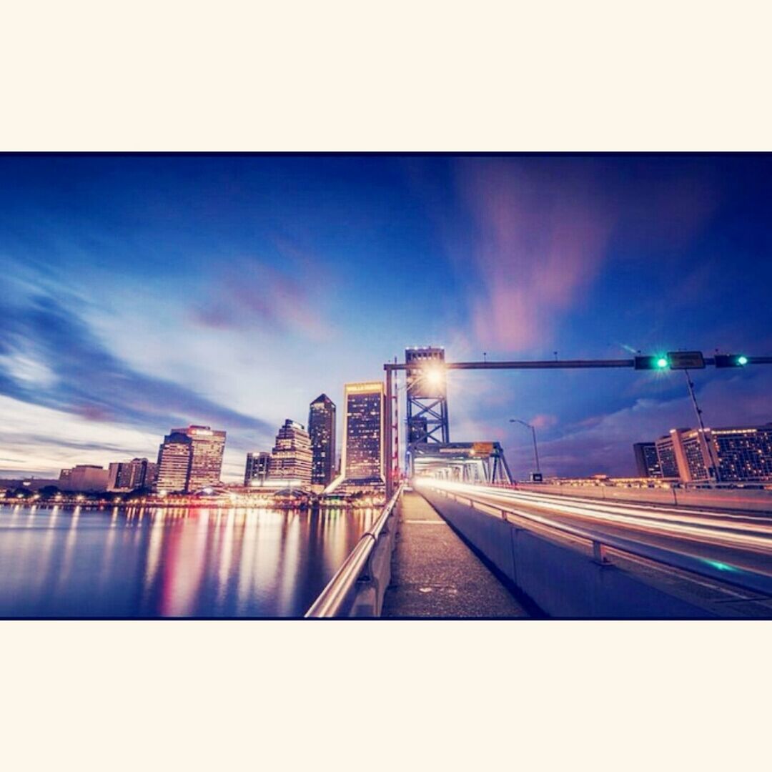 architecture, built structure, building exterior, transfer print, city, sky, auto post production filter, bridge - man made structure, illuminated, connection, transportation, cloud - sky, blue, dusk, cityscape, river, cloud, bridge, city life, outdoors