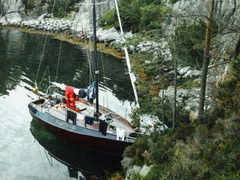 Boat sailing on sea by trees