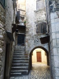 Narrow alley amidst buildings in city