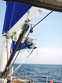 Sailboat sailing in sea against sky