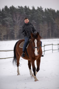 Full length of horse on snow field against sky
